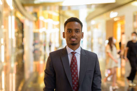 Portrait of African businessman wearing suit and tie indoorsの写真素材