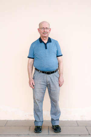 Full length portrait of senior man looking at cameraの写真素材