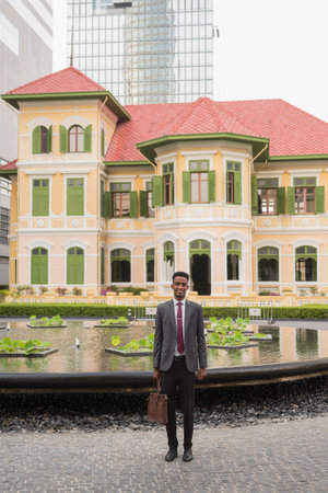 Portrait of young successful African businessman outdoors