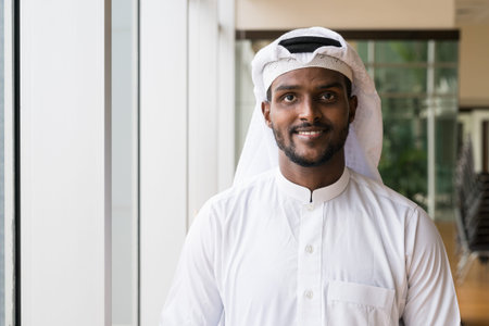 Portrait of young African Muslim man wearing religious clothing an scarf