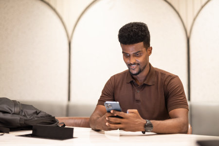Portrait of young handsome black man at coffee shop