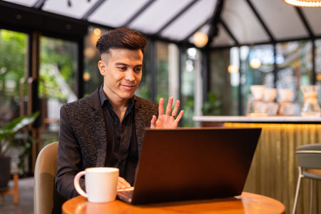 Young businessman using laptop computer in coffee shop