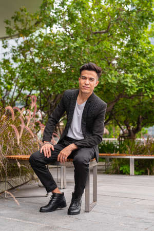 Portrait of handsome young businessman outdoors in cityの写真素材