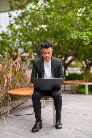Portrait of handsome young businessman outdoors in cityの写真素材
