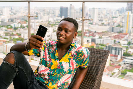Portrait of handsome young African man enjoying summerの写真素材