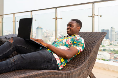 Portrait of handsome young African man enjoying summerの写真素材