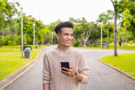 Portrait of young man in park during summerの写真素材