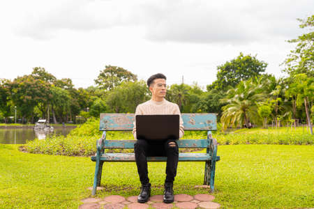 Portrait of young man in park during summerの写真素材
