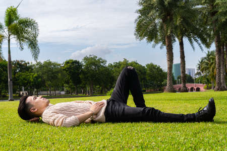 Portrait of young man in park during summerの写真素材