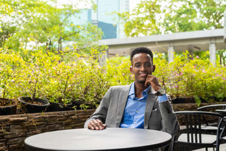 Handsome young black businessman outdoors in cityの写真素材