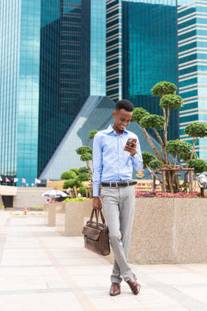 Handsome young black businessman outdoors in cityの写真素材