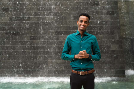 Portrait of handsome young black man outdoors during summerの写真素材