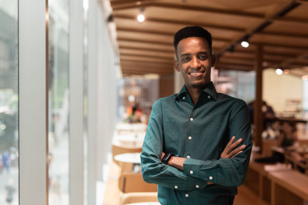 Portrait of handsome young black man in coffee shop horizontal shot