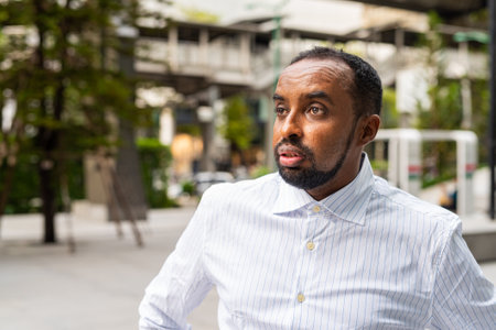Portrait of handsome black businessman in cityの写真素材