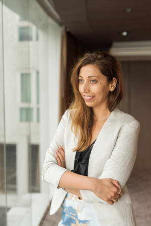 Portrait of beautiful businesswoman in office next to window