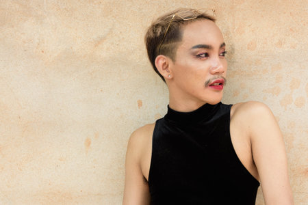 Portrait of beautiful Asian queer LGBT community supporter man with mustache wearing lipstick and...