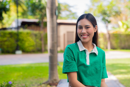 Young beautiful woman in a park smiling happilyの写真素材