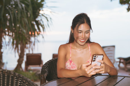 Summer beach portrait of happy young beautiful Asian womanの写真素材