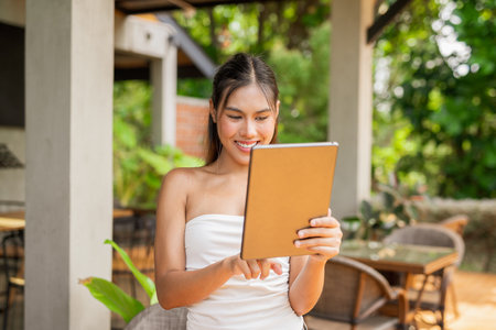 Young woman using tablet computer in cafeの写真素材