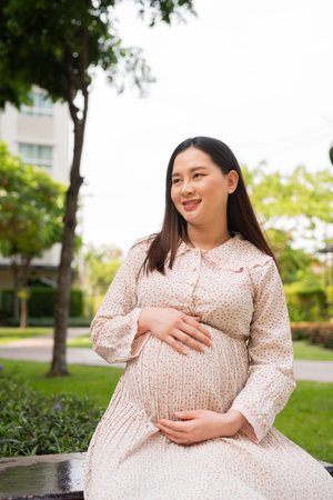 Pregnant Asian woman portrait outdoorsの写真素材