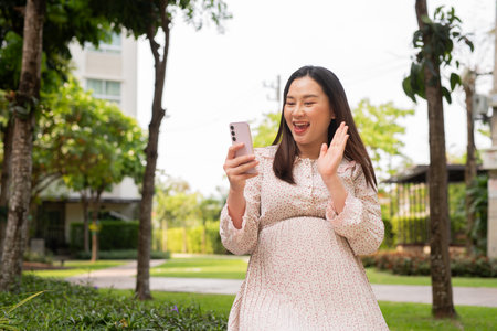 Pregnant Asian woman portrait outdoorsの写真素材