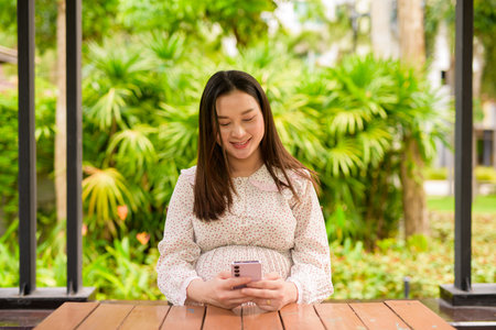 Pregnant Asian woman portrait outdoorsの写真素材