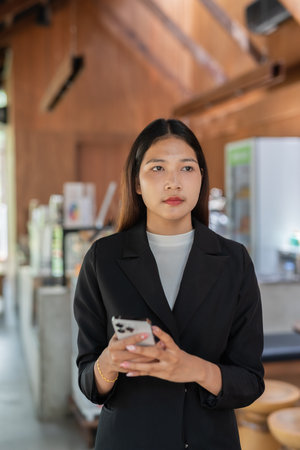 Portrait of young woman wearing business clothes in cafe restaurantの写真素材