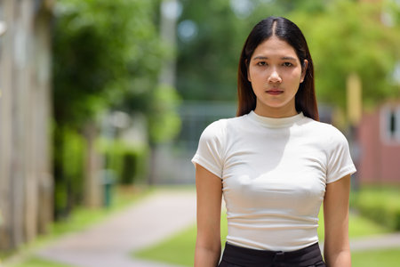 Portrait of Asian woman outdoors during sunny dayの写真素材
