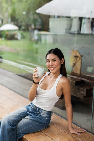 Portrait of young beautiful happy woman in cafeの写真素材