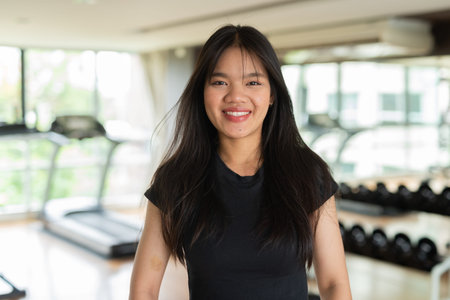 Young beautiful Asian fitness woman exercising in gymの写真素材