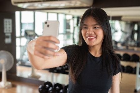 Young beautiful Asian fitness woman exercising in gymの写真素材