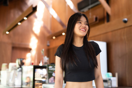 Young beautiful Asian student woman in cafeの写真素材