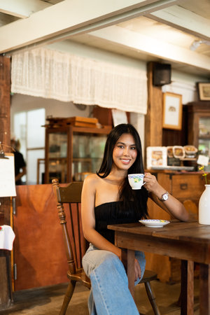 Young beautiful Asian woman in coffee shopの写真素材