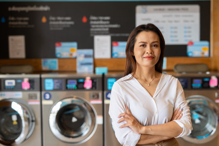 Portrait of beautiful Asian woman in laundry shopの写真素材