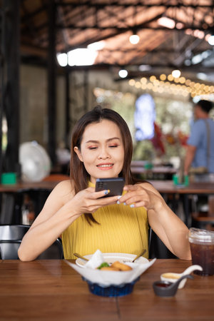 Portrait of beautiful Asian woman sitting in restaurant