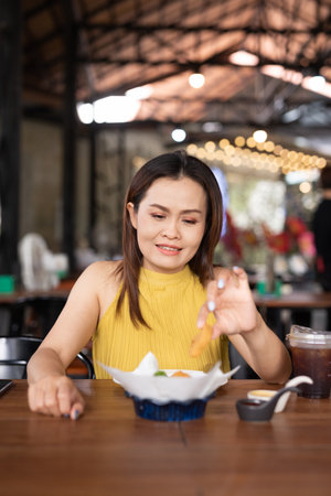 Portrait of beautiful Asian woman sitting in restaurantの写真素材