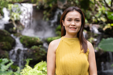 Portrait of beautiful Asian woman in Zen style garden parkの写真素材