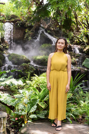 Portrait of beautiful Asian woman in Zen style garden parkの写真素材