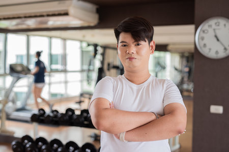 Young cute gay man athlete exercising in fitness gym during dayの写真素材