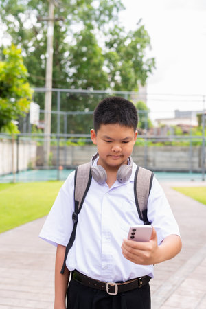 Asian Schoolboy Relaxing in Park After Classの写真素材