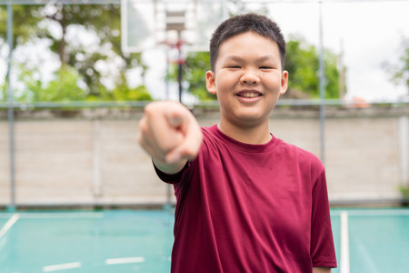 Asian Teenage Boy on Basketball Court in Sportswearの写真素材