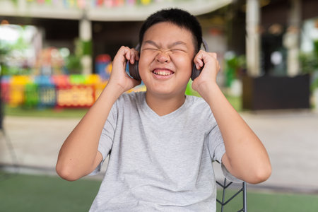 Teenage boy listening music with headphones outdoorsの写真素材