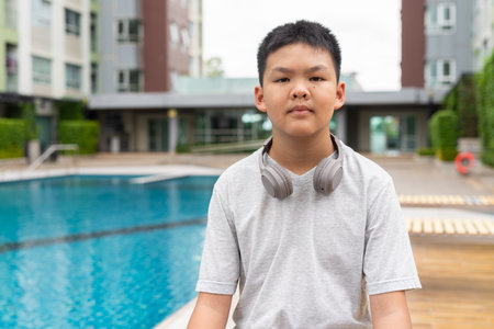 Asian Teenage Boy at Poolside During Summerの写真素材