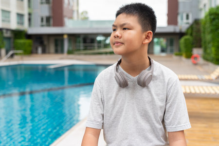 Asian Teenage Boy at Poolside During Summerの写真素材