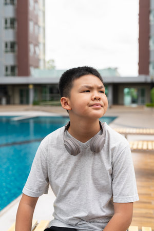 Asian Teenage Boy at Poolside During Summerの写真素材