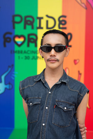 Portrait of confident non binary Asian gay man during pride outdoors