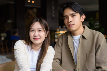 Portrait of a happy young couple indoors in cafeの写真素材