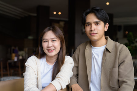 Portrait of a happy young couple indoors in cafeの写真素材