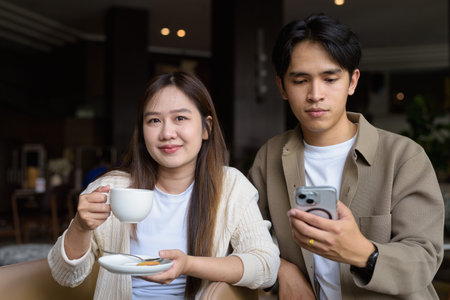 Young happy couple drinking coffee in cafe restaurant
