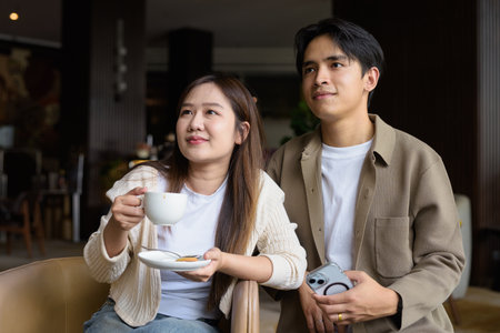 Young happy couple drinking coffee in cafe restaurantの写真素材